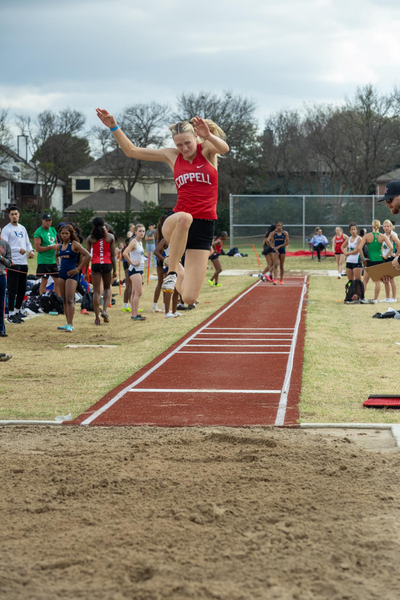 Coppell junior Mia Schuller long jumps at the Coppell Relays at Buddy Echols Field on March 5. Schuller's siblings are her main inspiration for running track. Photo courtesy Henry Mink/Round-Up yearbook