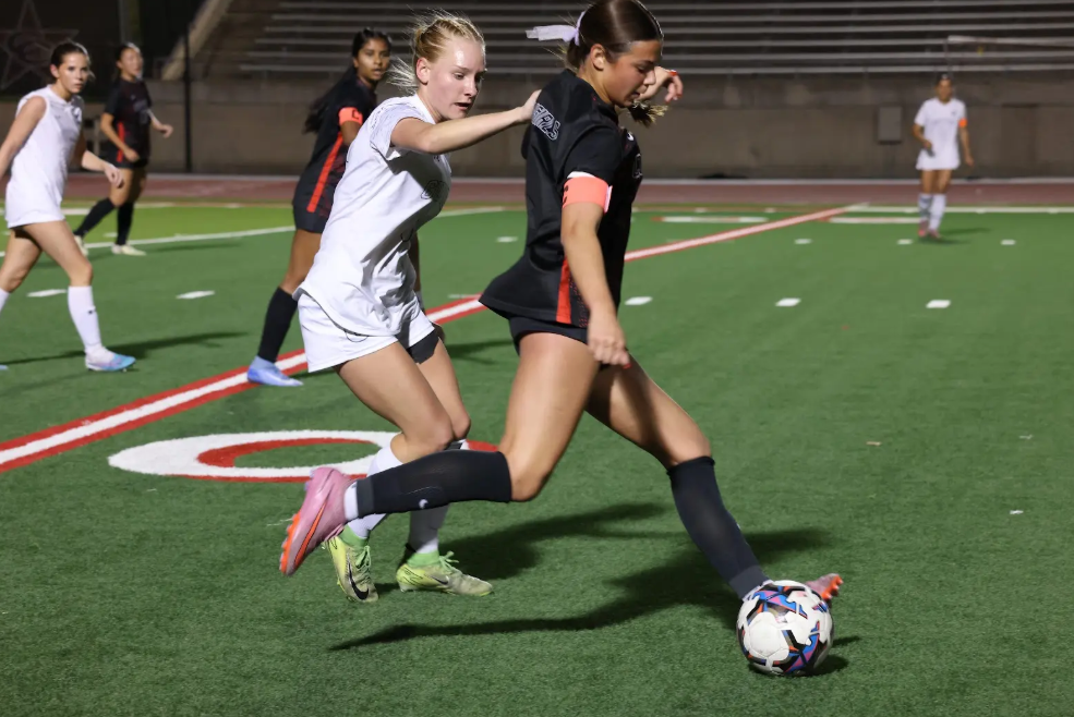 Coppell junior forward Emeline Holder passes against Denton Guyer on Feb. 20 at Buddy Echols Field. The Cowgirls host Flower Mound on Friday at Buddy Echols Field. 