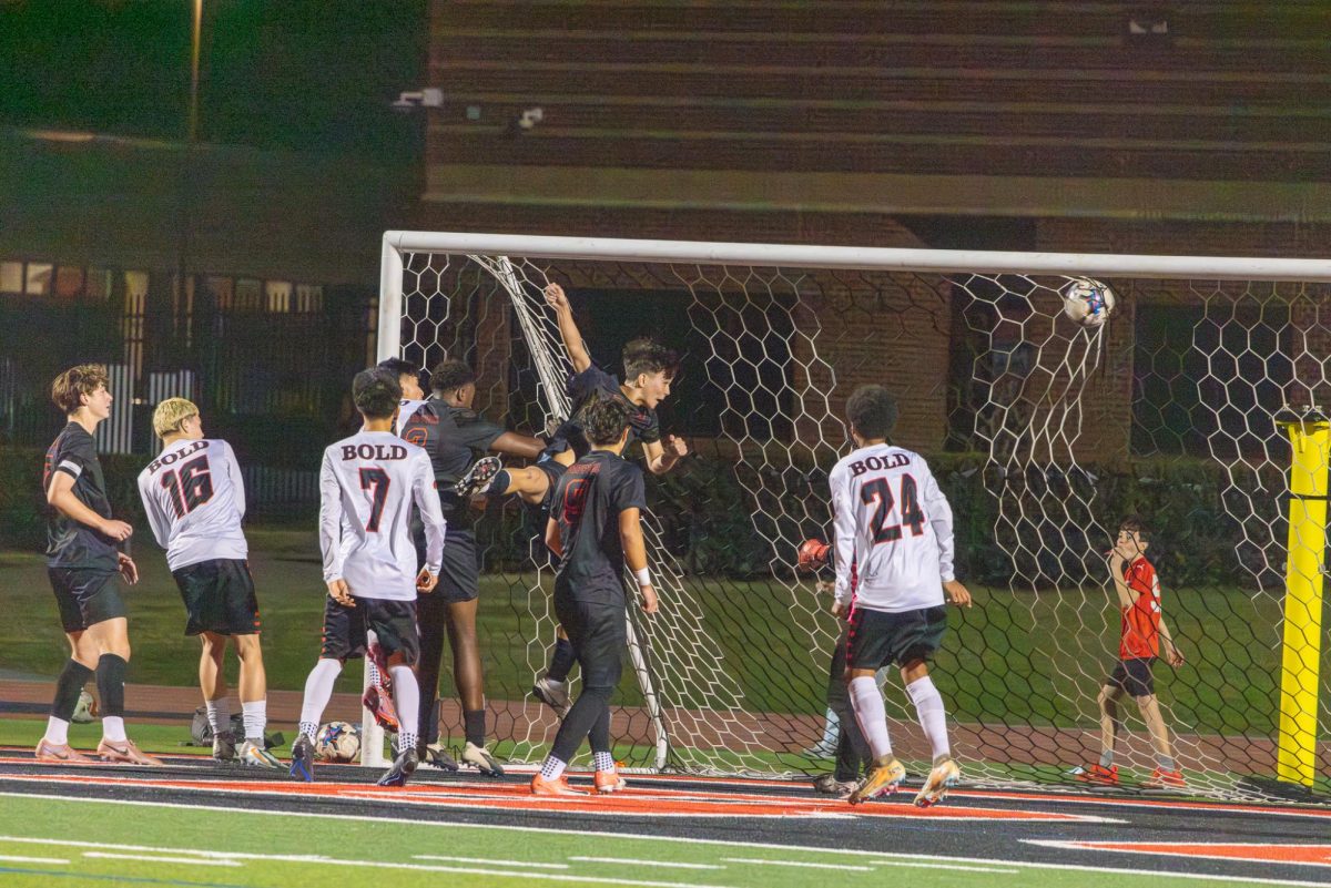 Coppell senior midfielder Justice Ihezie scores a goal against Denton Braswell on Tuesday at Buddy Echols Field. The Cowboys defeated the Bangles 2-1. photo by Karen Mascarenhas 
