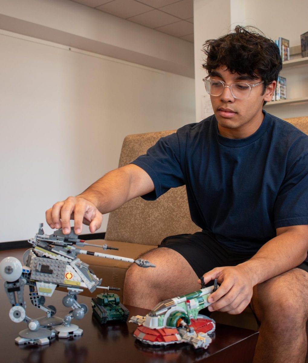 The Sidekick editor-in-chief Yug Talukdar inspects the LEGO sets he built. For Talukdar, LEGO holds a lasting place in his heart, serving as the foundation for the imagination shaping much of his childhood.