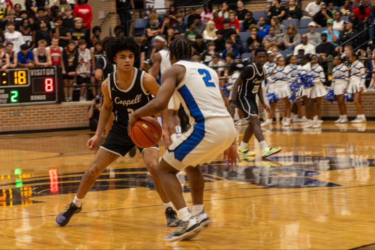 Coppell senior guard Isaiah Fleming plays defense against North Crowley junior guard Kameron Price on Tuesday at Timberview High School in Mansfield. The Panthers defeated the Cowboys, 71-40, in the Class 6A regional semifinals, marking the end of their season. Photo by Reece Murry