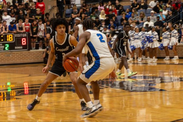 Coppell senior guard Isaiah Fleming plays defense against North Crowley junior guard Kameron Price on Tuesday at Timberview High School in Mansfield. The Panthers defeated the Cowboys, 71-40, in the Class 6A regional semifinals, marking the end of their season. Photo by Reece Murry