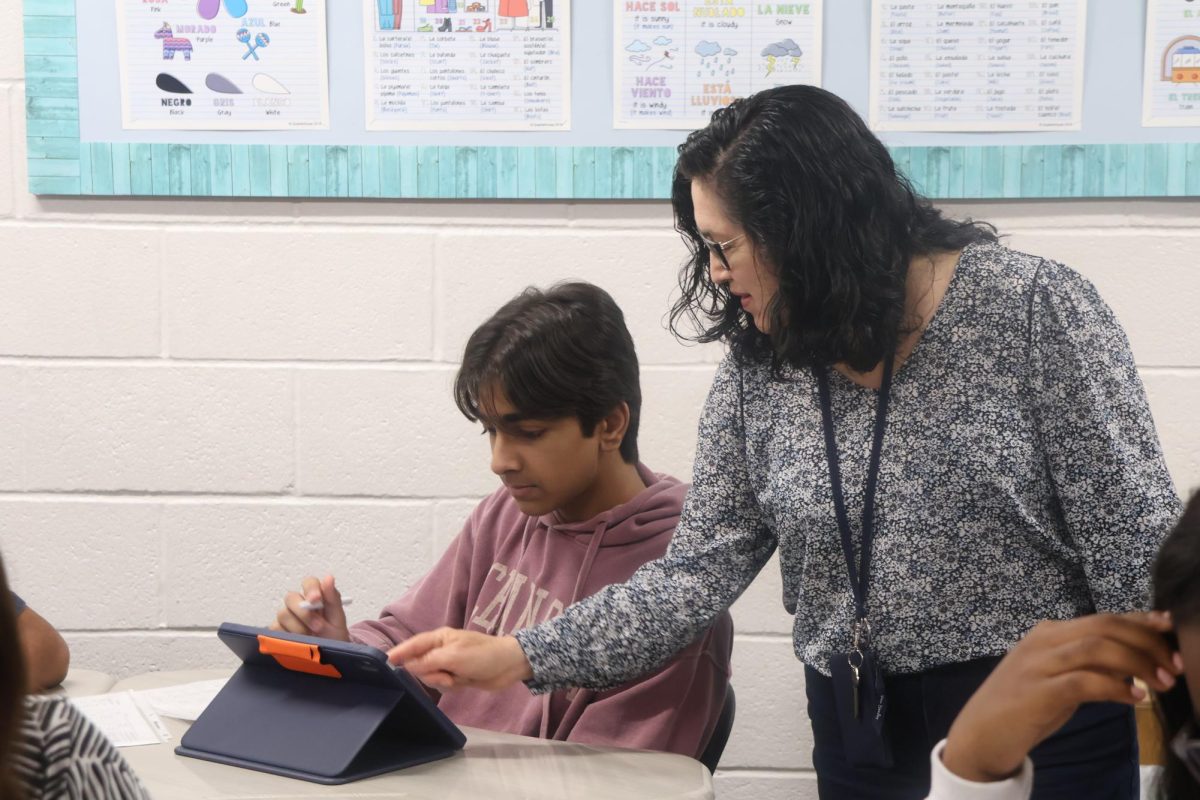 CHS9 Spanish teacher Miriam Romero Muller assists freshman Taurav Rao with Spanish pronouns and verb conjugations during class. Romero Muller, who teaches Spanish I and II at CHS9, is known for her supportive approach while building strong connections with them throughout the year. 