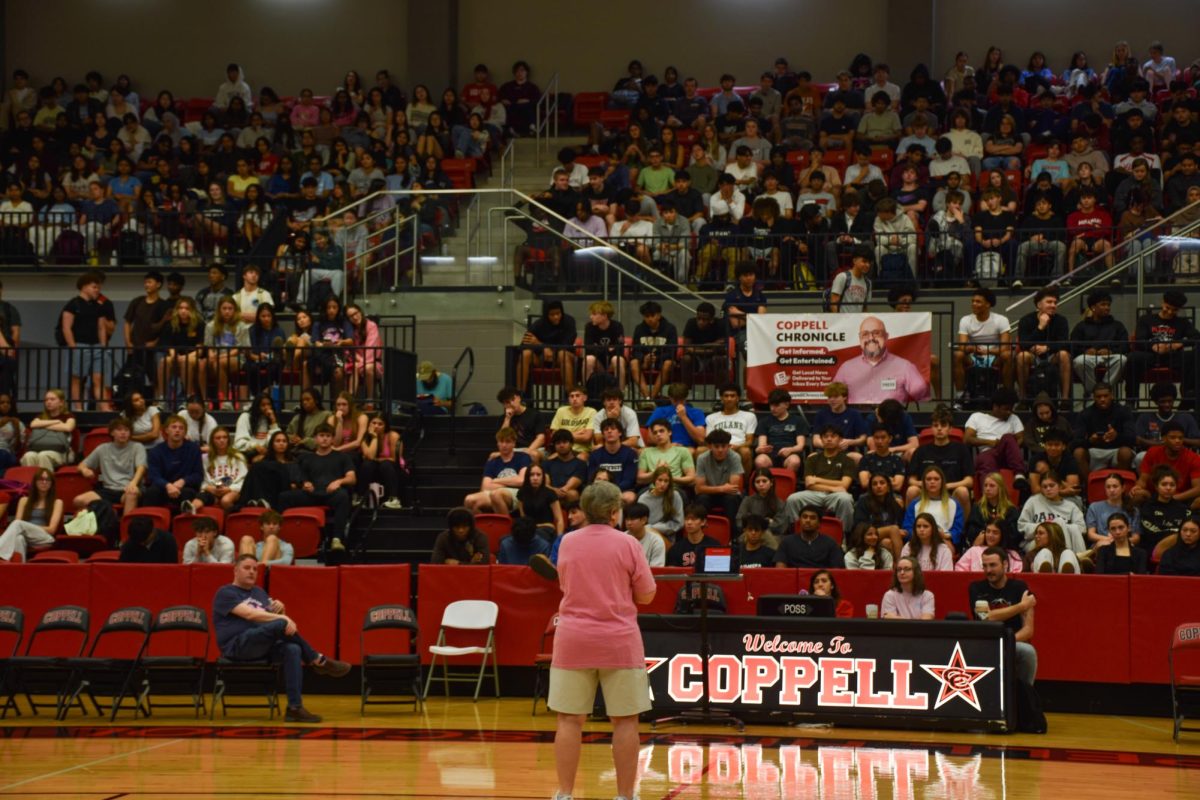 Coppell High School Principal Laura Springer addresses 2026 seniors about how excited she is for their end-of-year graduation events on Wednesday morning in CHS Arena. Coppell seniors met to plan for upcoming events and receive their cap and gown.