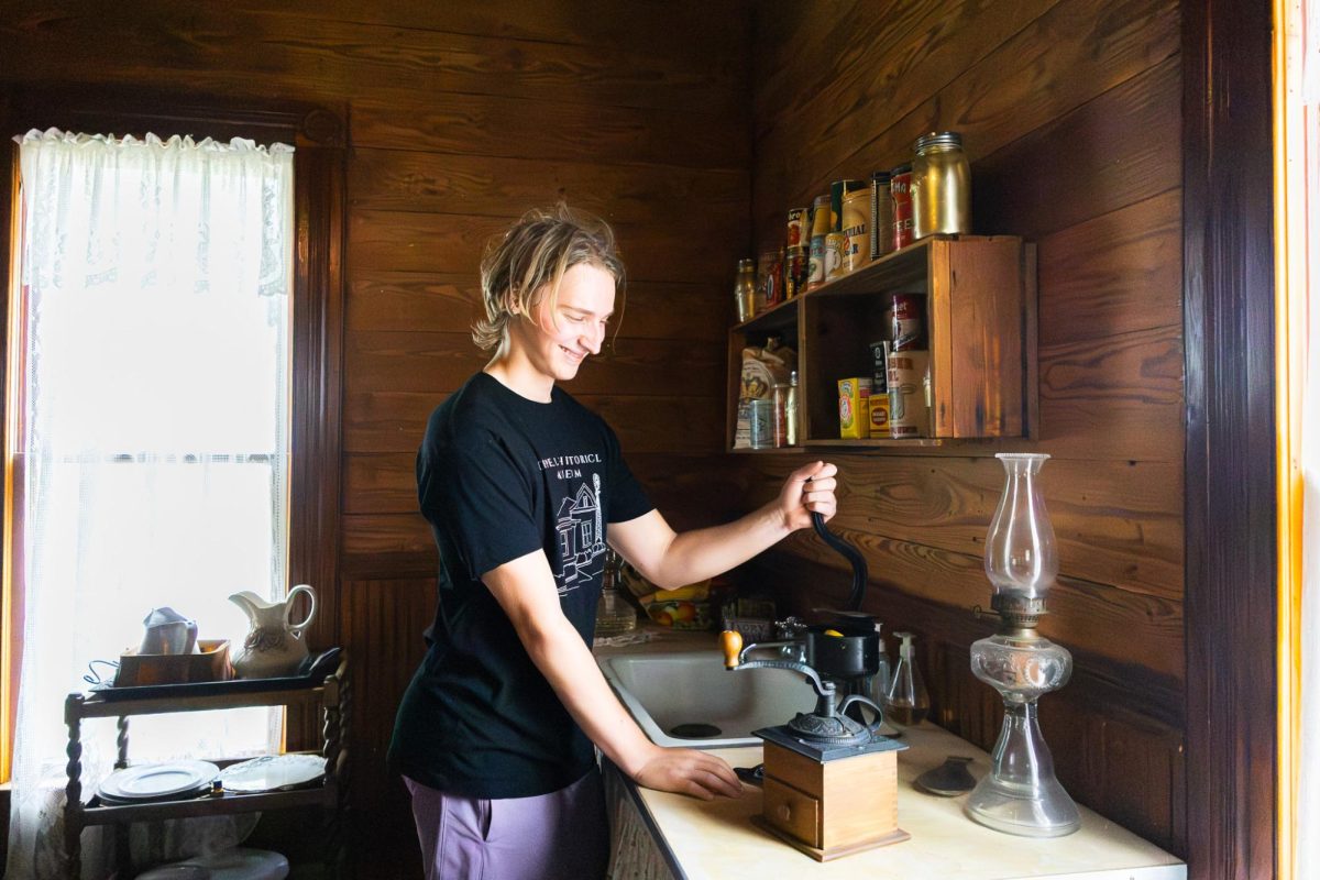 Baylor University sophomore and author Gedeon Bring uses an antique juice presser at the Coppell Historical Museum. Bring enjoys learning about local history and is a professional drummer for the Colton Hamilton band.