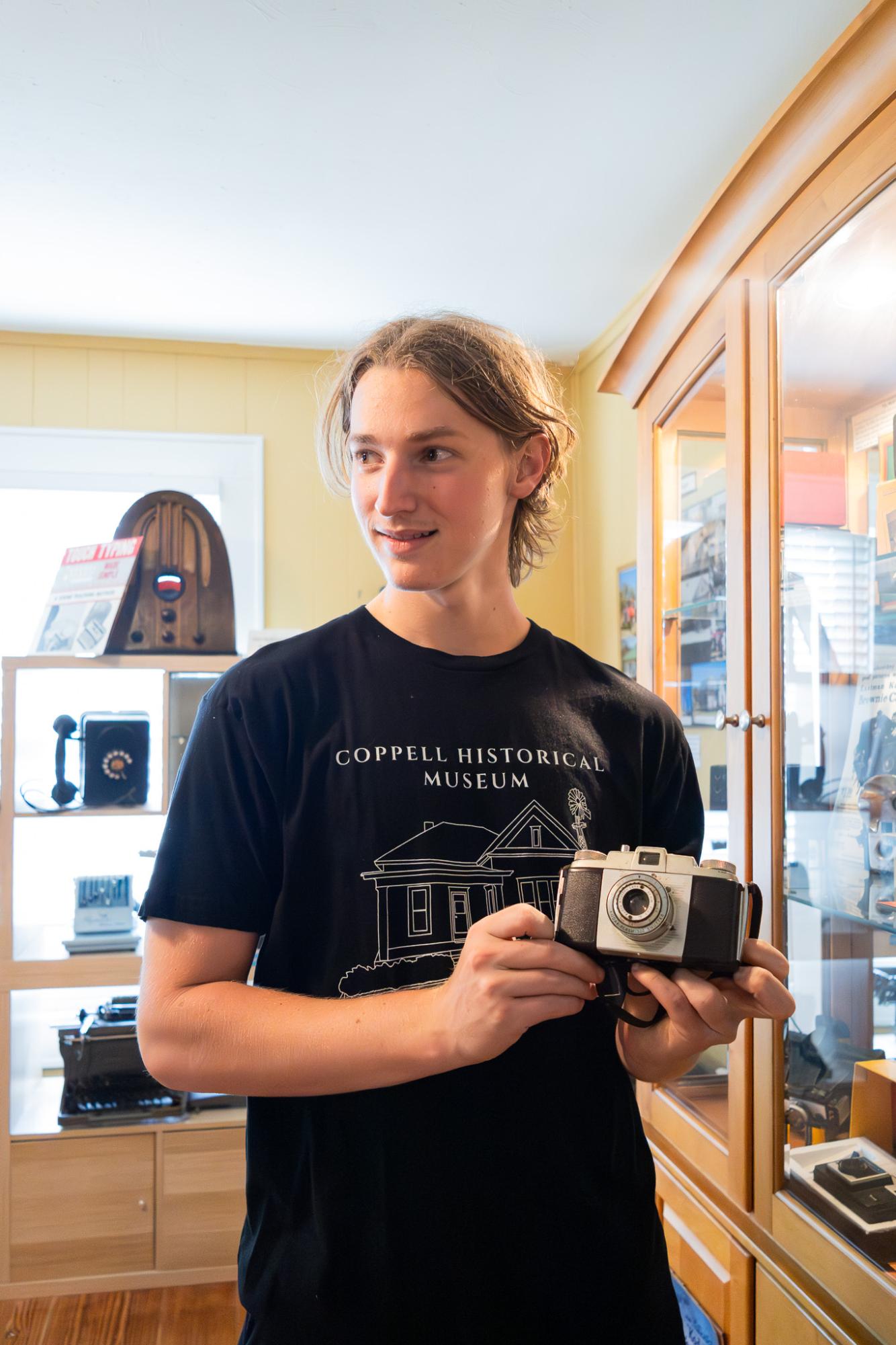Baylor University sophomore and author Gedeon Bring demonstrates the functions of a vintage Kodak film camera at the Coppell Historical Museum. Bring enjoys learning about local history and is a professional drummer for the Colton Hamilton band.