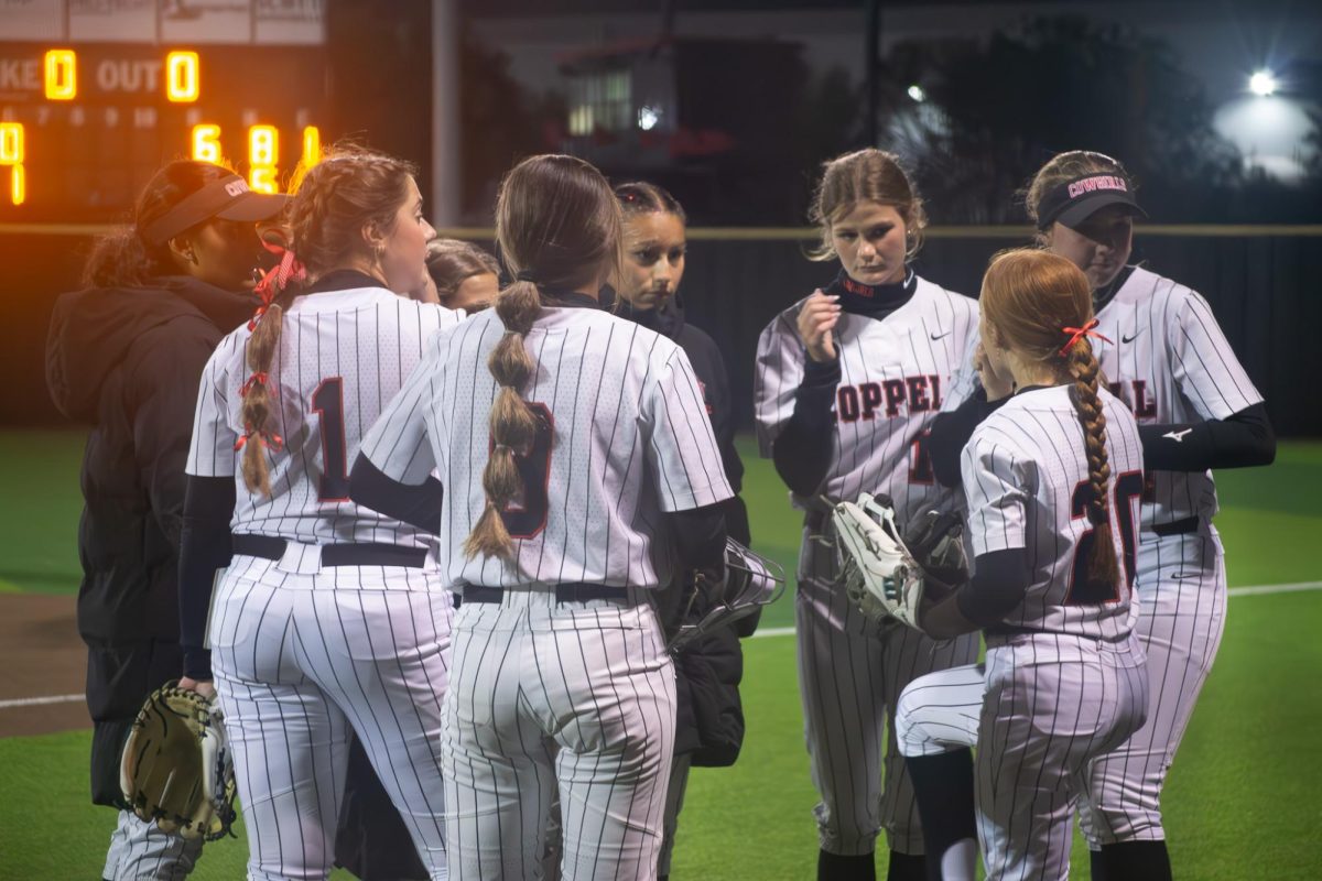 Coppell softball team huddles against Hebron on March 30 at Coppell ISD Softball/Baseball Complex. The Hawks defeated the Cowgirls, 7-3.