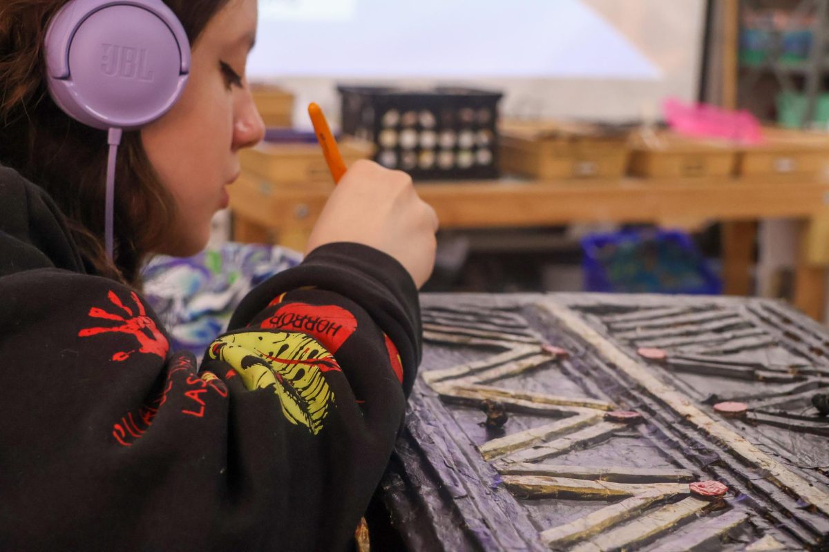 Junior Natalie Shepherd finishes painting a wardrobe she made for her Art II Sculpture class on April 7. The Sidekick staff writer Clara Lane encourages students to explore hobbies to help them find interests beyond school. 
