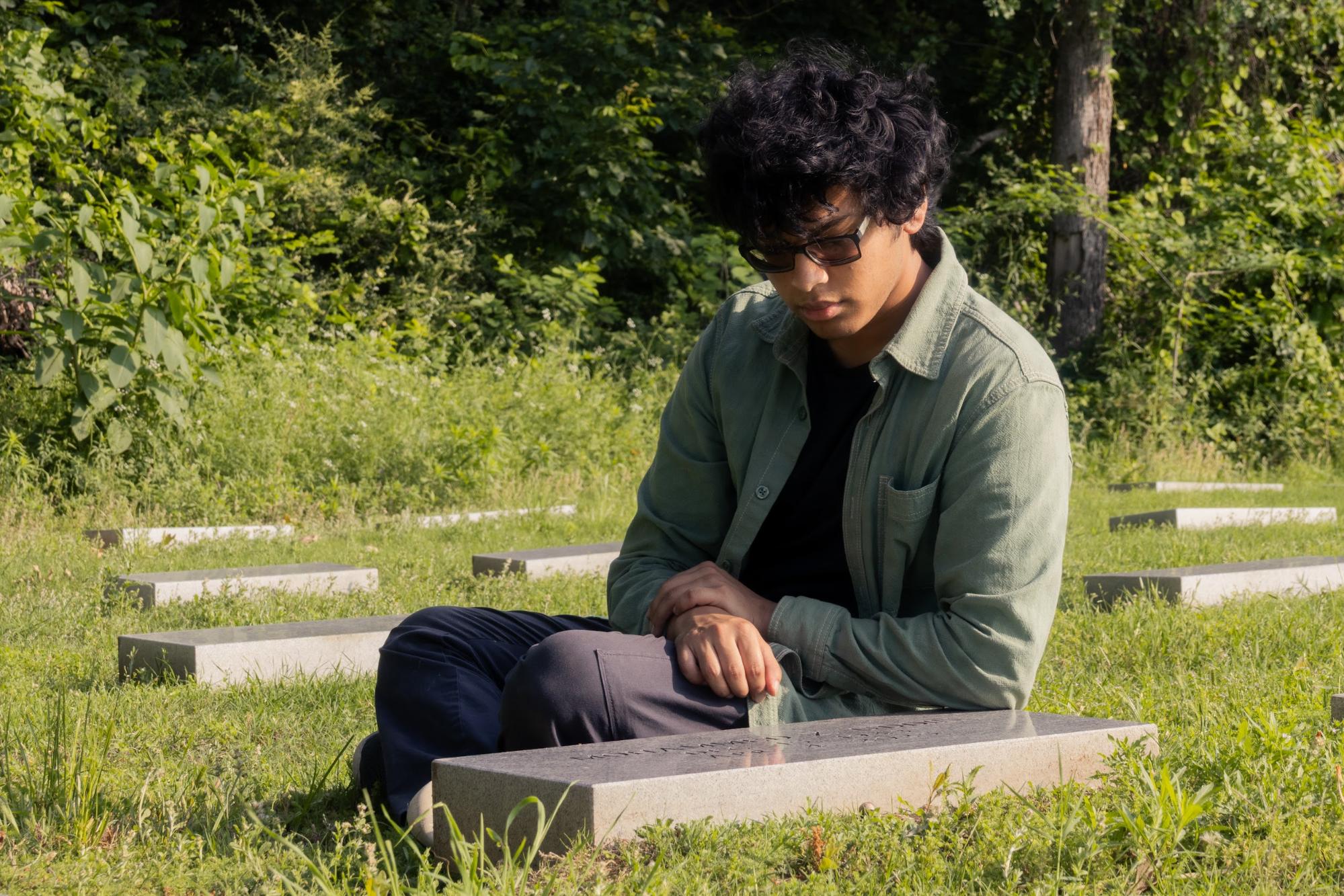 The Sidekick editorial page editor Hamza Zakir pays homage to his grandfather, Mohammed Z. Uddin, at his grave at Rolling Oaks Memorial Center in Coppell. Zakir remembers the story of his grandfather’s passing on April 4, 2025.
