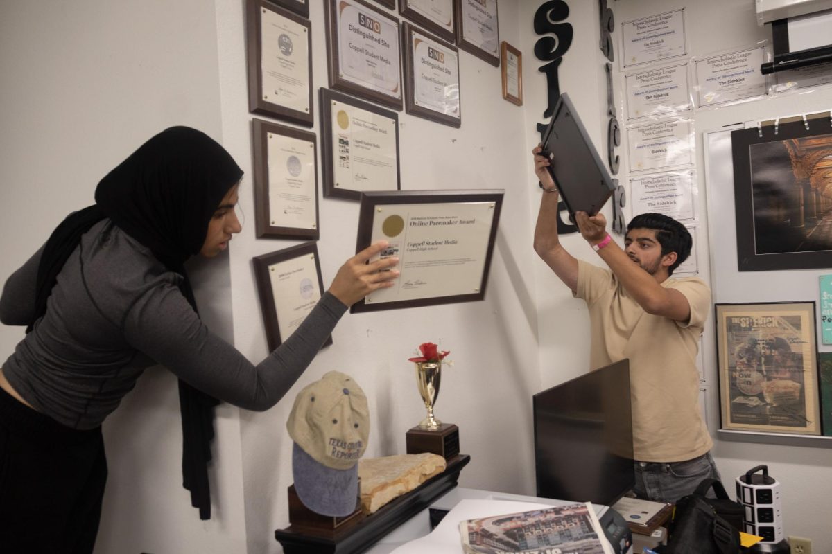 The Sidekick sports photography/social media editor Naila Ali and staff photographer Ayaan Salaar remove NSPA Pacemaker Awards off the wall on Monday in room D115. The Sidekick is packing up the room and relocating to room D113 for the 2026-27 school year.