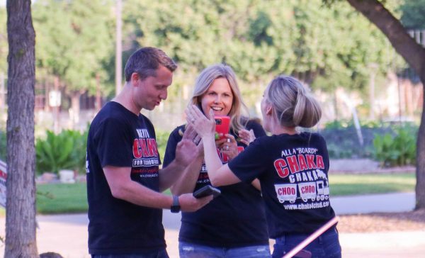 Coppell ISD Board of Trustees Place 5 candidate Kevin Chaka reviews voting results as his wife Holly Chaka and campaign manager Tiffany Tai celebrate his election on Saturday at Coppell City Hall. Chaka won Place 5 against candidate Khanh Windham.