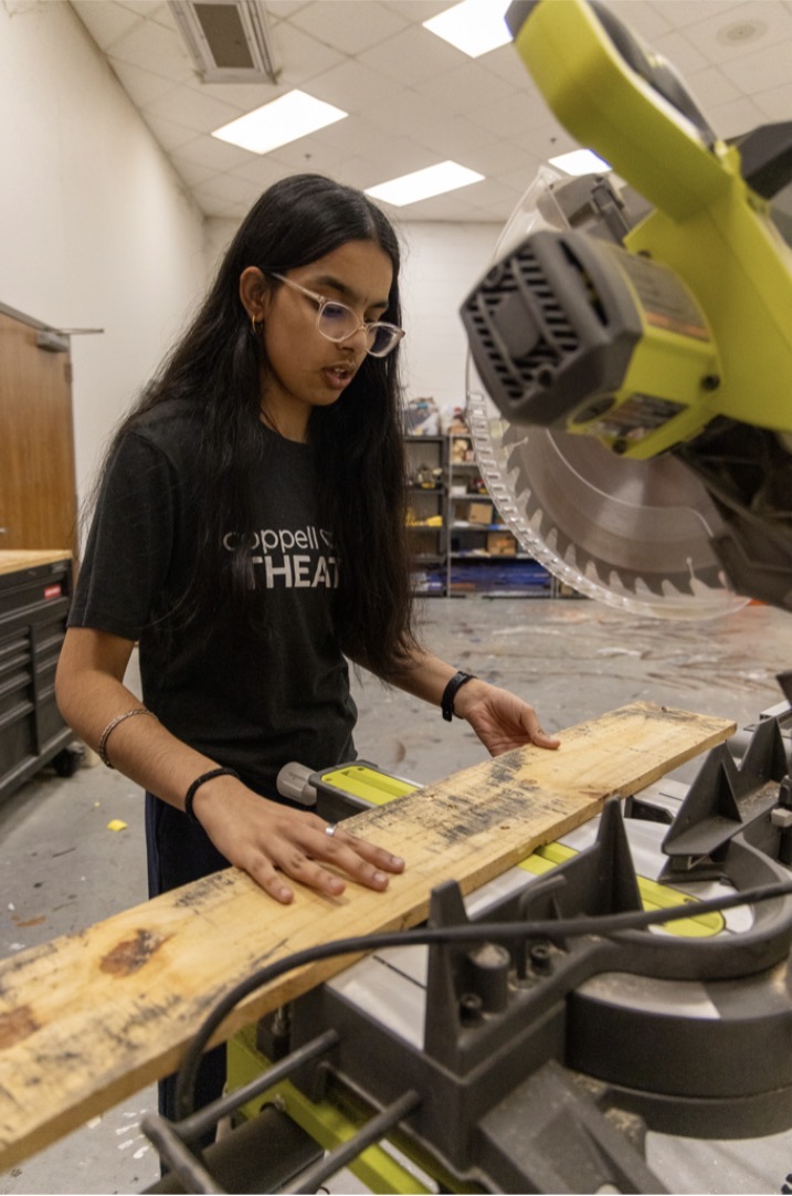 New Tech High @ Coppell freshman Mackenzie Smith and CHS9 student Meenakshi Murthy outline wood for the musical “SIX: Teen Edition" set on May 13 at CHS9 shop room. Murthy showcases ownership and responsibility through stage management for the upcoming production. 
