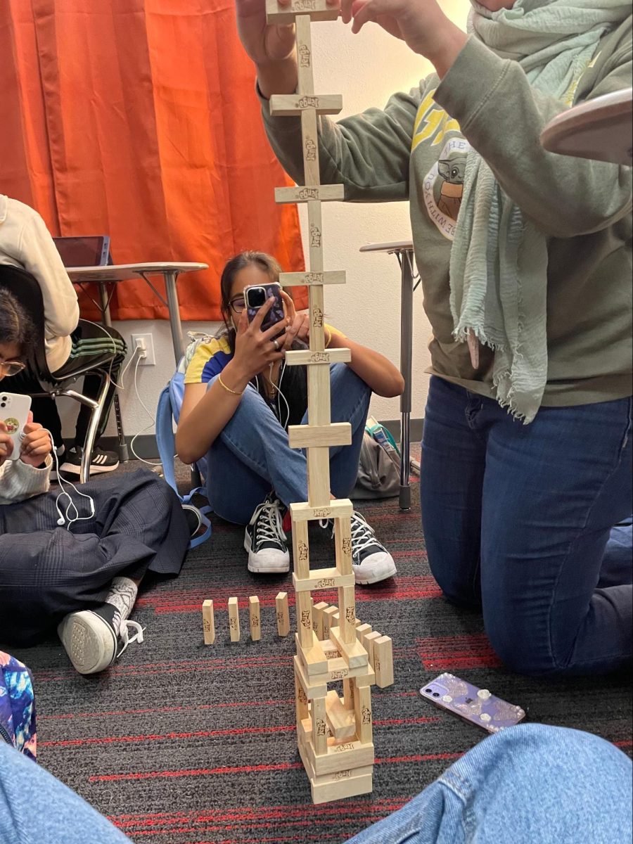 The Sidekick staff designer Chloe Vigue takes a picture of staff writer Hiral Patel while they play Jenga in Erin Begle’s room at CHS9. Senior Send-off is a series of recognitions for graduating Sidekick seniors. 